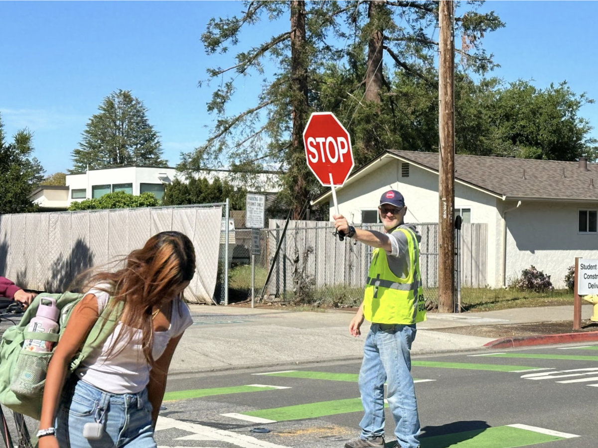 Los Altos High School’s crossing guard Steven Perdriau guides students across the crosswalk during his shift.